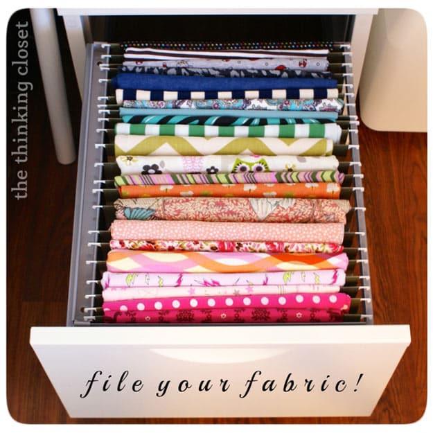 File and organize your fabric, a file drawer of folded fabrics standing upright in rainbow order between white folder