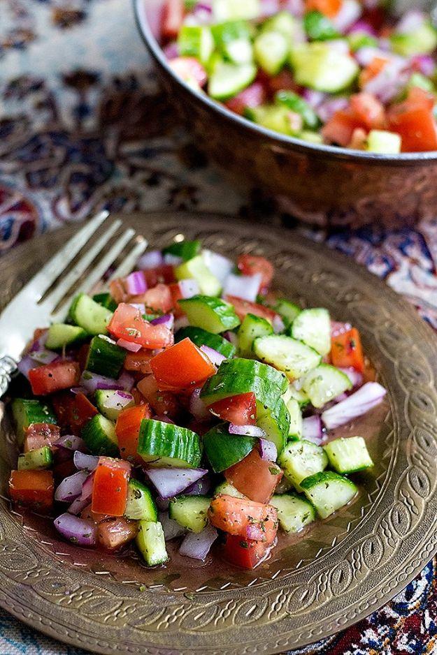 Salad Shirazi on an ornate plate with finely diced cucumber, tomato and red onion, bowl of salad behind