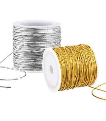 Spools of silver and gold metallic elastic cord used to make hanging loops for handmade Christmas ornaments