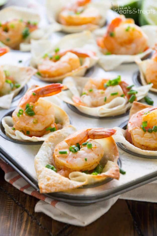 Light Tex Mex shrimp bites, baked wonton cups in a mini muffin tin, each holding a whole shrimp and chives