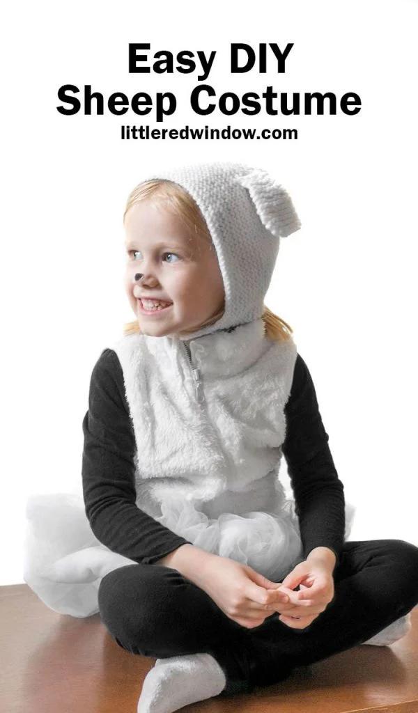 Child wearing a white sherpa sheep costume with black clothes, a white tutu and a knitted lamb-ear bonnet