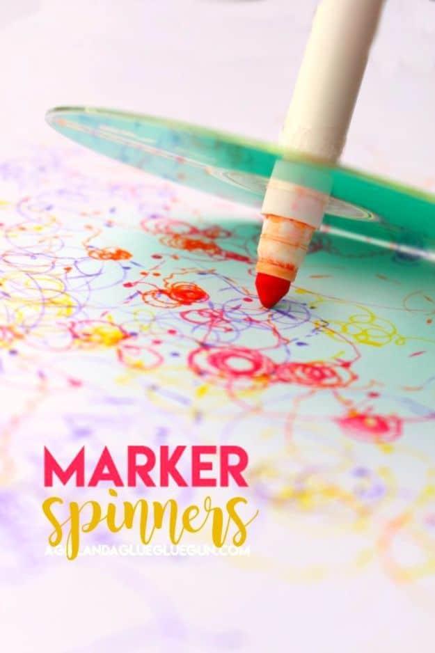 Marker spinner made from a green CD with a fat marker taped through the center, drawing colored spirals