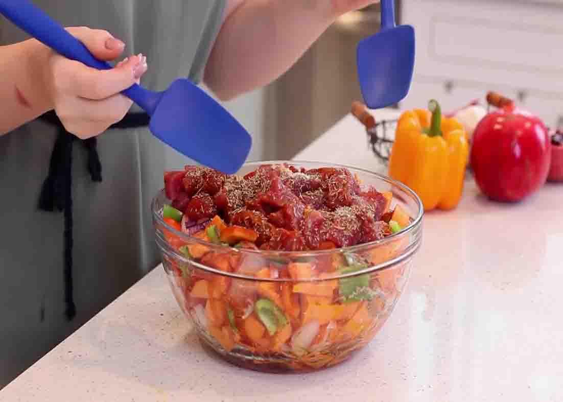 Tossing the pork and sweet potato casserole ingredients