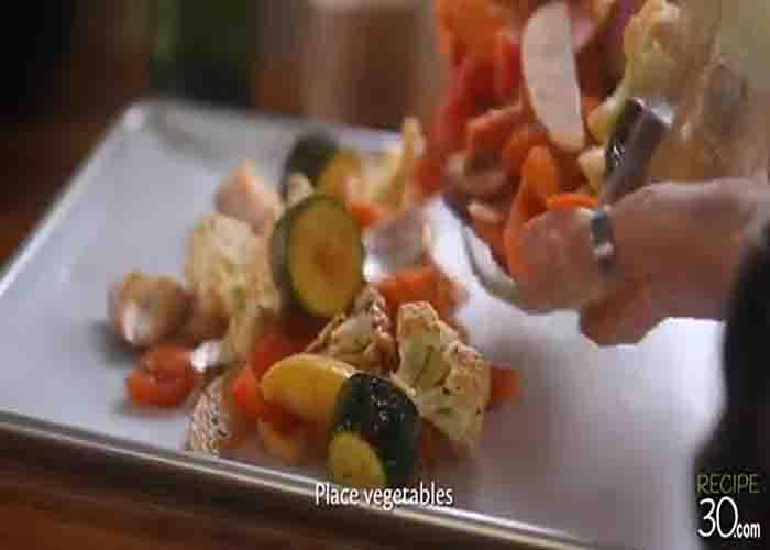 Scattering the veggies into the baking sheet