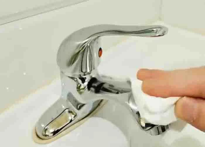 Smearing Vaseline into the faucet to make it shiny