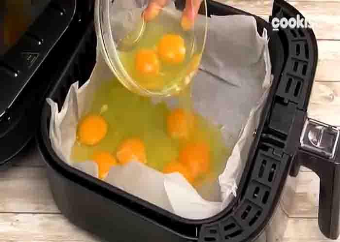 Adding the eggs in the air fryer basket