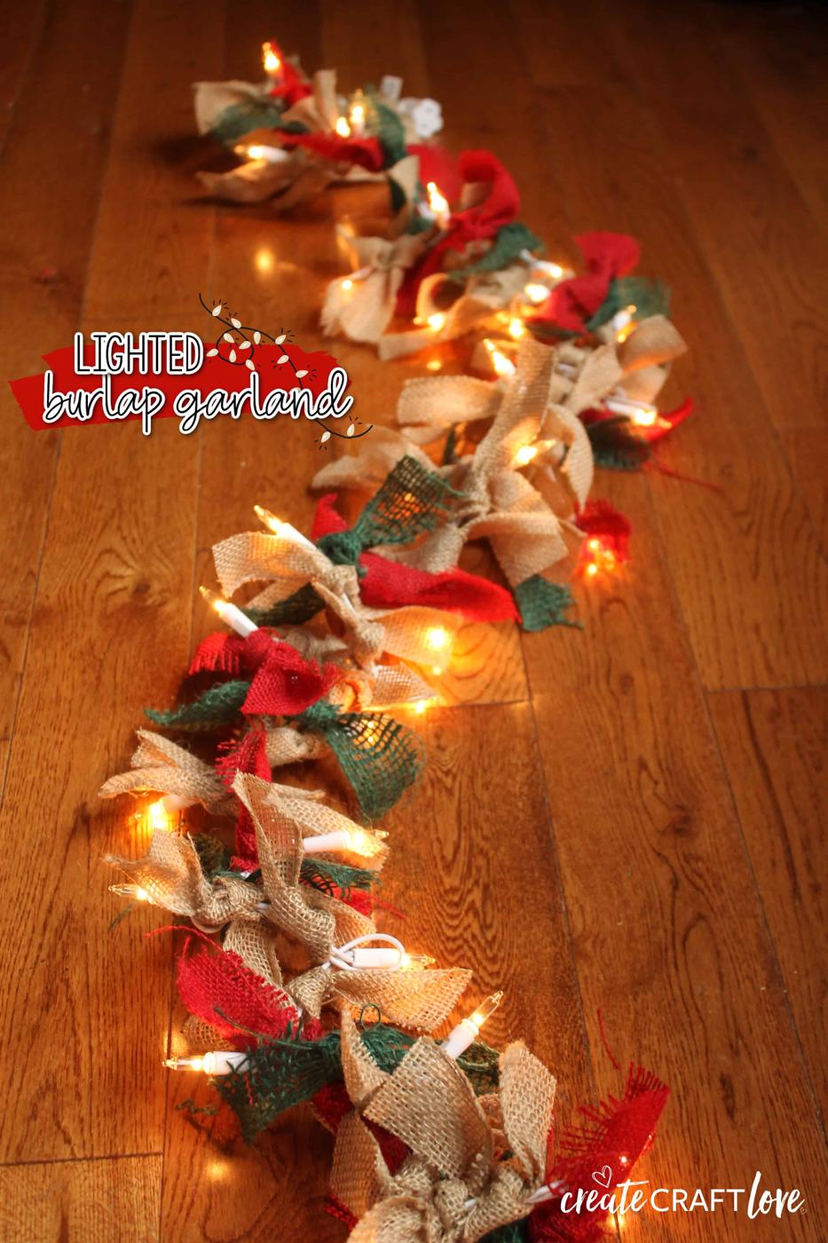 Lighted burlap garland with knotted strips of natural, red and green burlap ribbon tied along a string of white mini lights