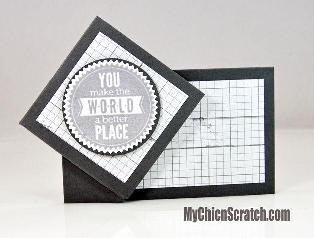 Black and white twist and turn card with a graph paper panel and a gray medallion reading you make the world