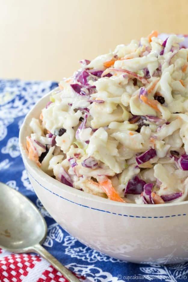 Maple Dijon apple coleslaw with shredded cabbage, carrot and apple in a creamy dressing in a white bowl
