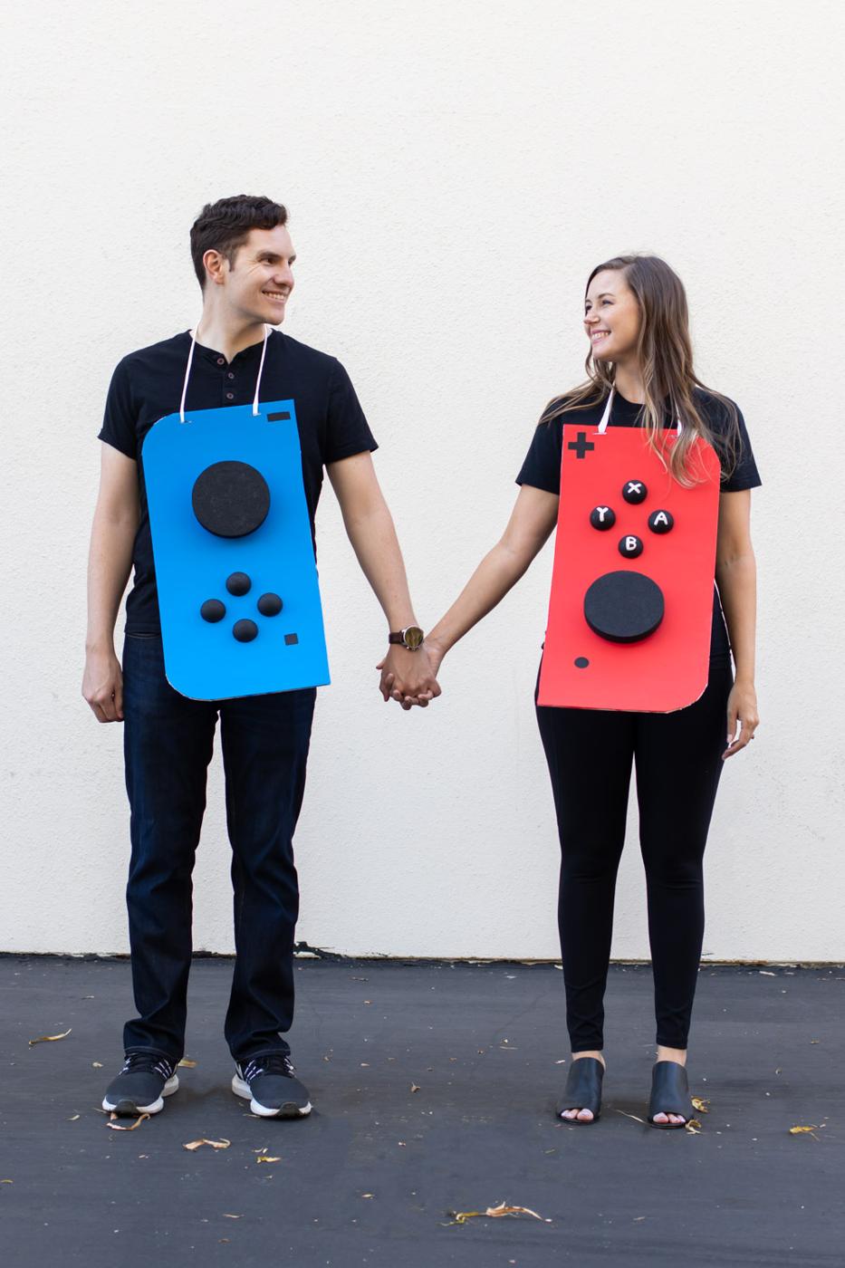 DIY Nintendo Switch couples costume with red and blue painted posterboard Joy Cons worn sandwich board style