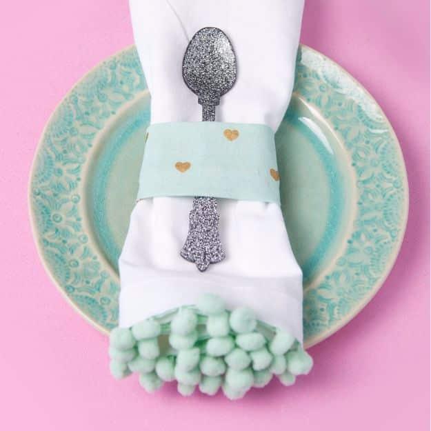 DIY Pom Pom Napkins, one of the best napkin and placemat ideas on this list and a simple idea that makes a real difference