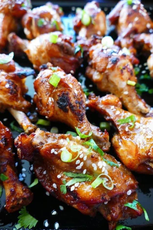 Easy Instant Pot teriyaki wings glazed dark and sticky, sprinkled with sesame seeds and sliced green onions