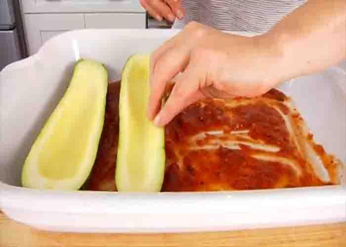 Laying the zucchini boats in the casserole dish