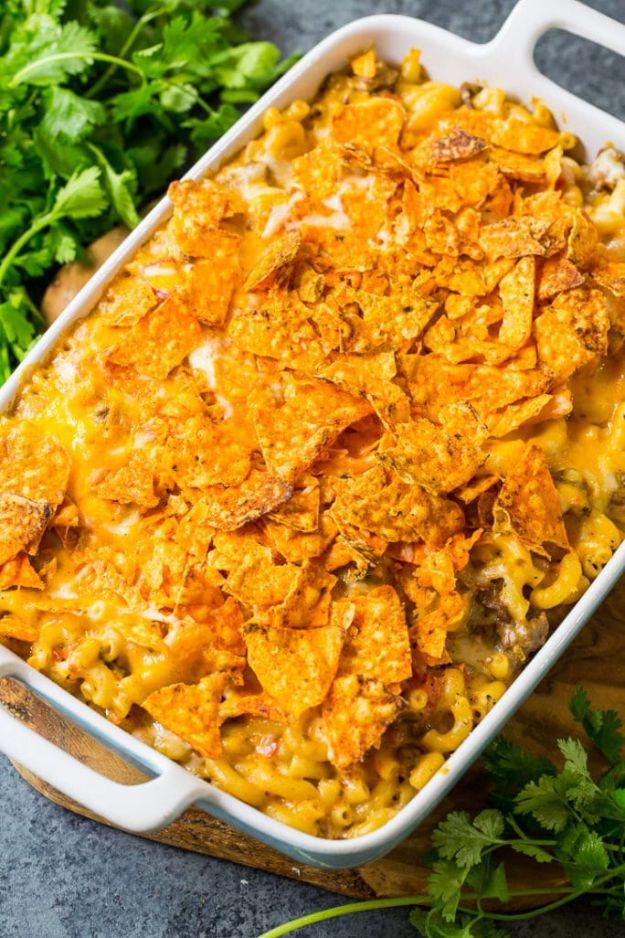 Nacho mac and cheese baked with taco ground beef under a crushed Doritos topping in a white rectangular dish