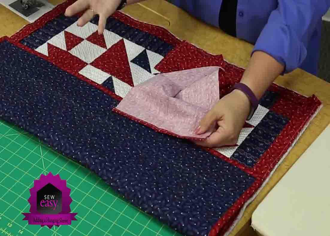 Folding the wide fabric to be used as a hanging sleeve