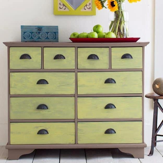 Dresser painted in two tone chalk finish paint with chartreuse green drawer fronts and shell shaped cup pulls