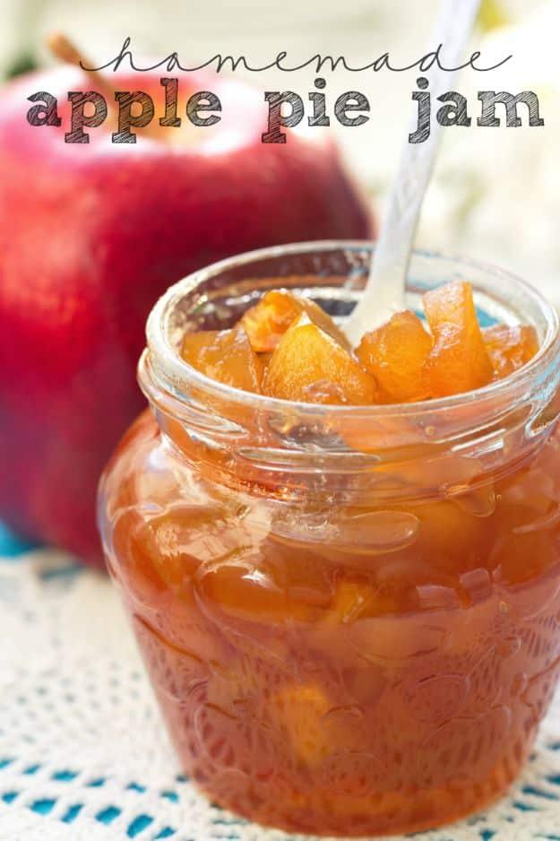 Homemade apple pie jam in a jar, thick and spiced with cinnamon, spooned onto a warm buttered biscuit