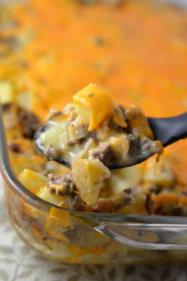 Ground beef and potato casserole with layered cubed potatoes, creamy sauce and browned cheddar topping
