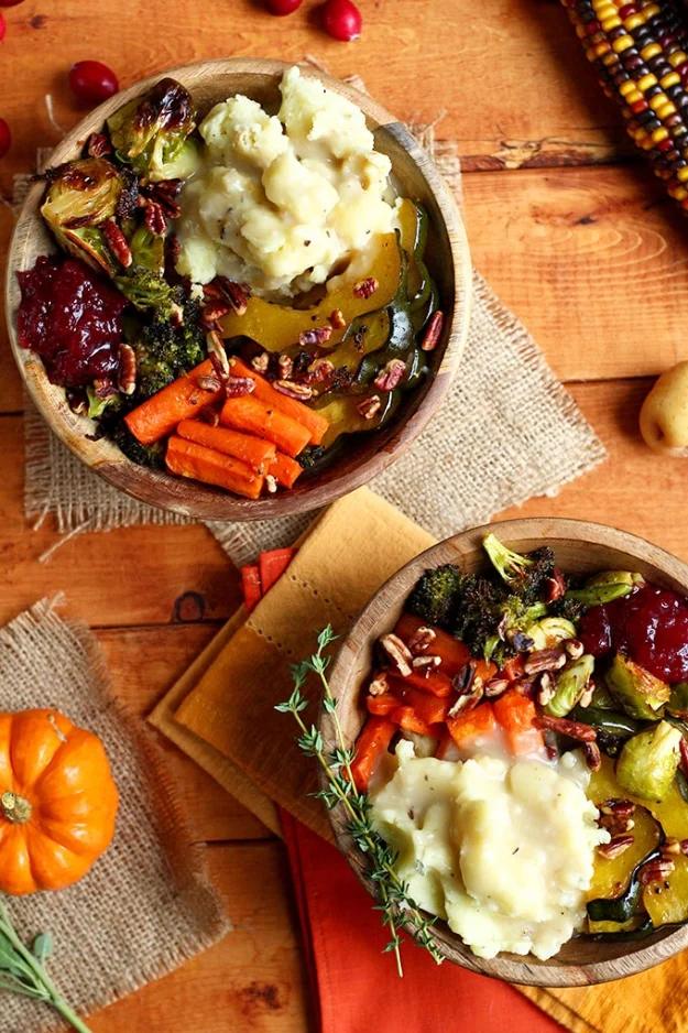 Roasted vegan Thanksgiving bowl with acorn squash, brussels sprouts, broccoli and mashed potatoes under gravy