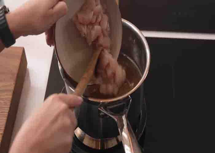 Adding the chicken to the soup broth