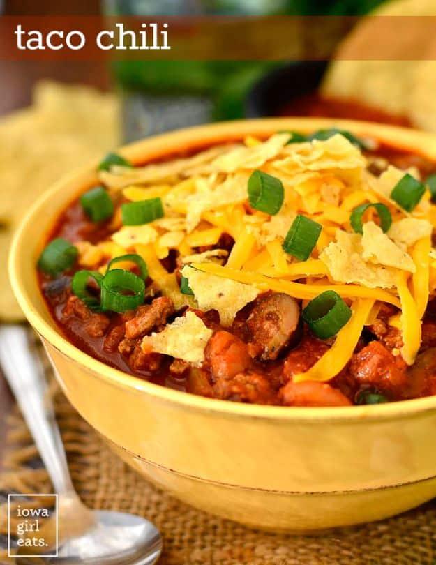 Typeset pin graphic of a gold bowl of taco chili topped with cheddar, green onion and broken tortilla chips