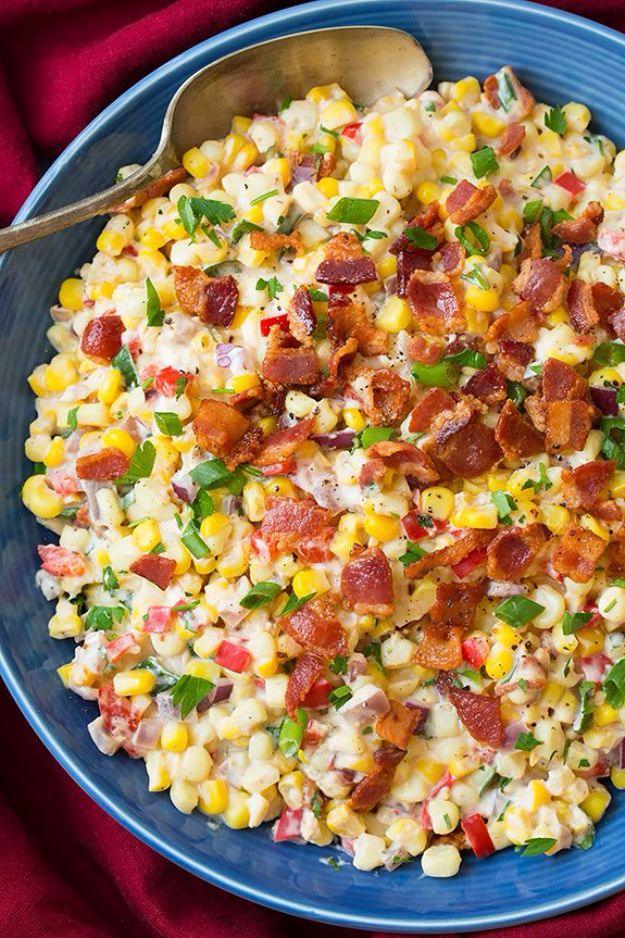 Creamy confetti corn with crisp bacon, red bell pepper, red onion and green onion in a white serving bowl