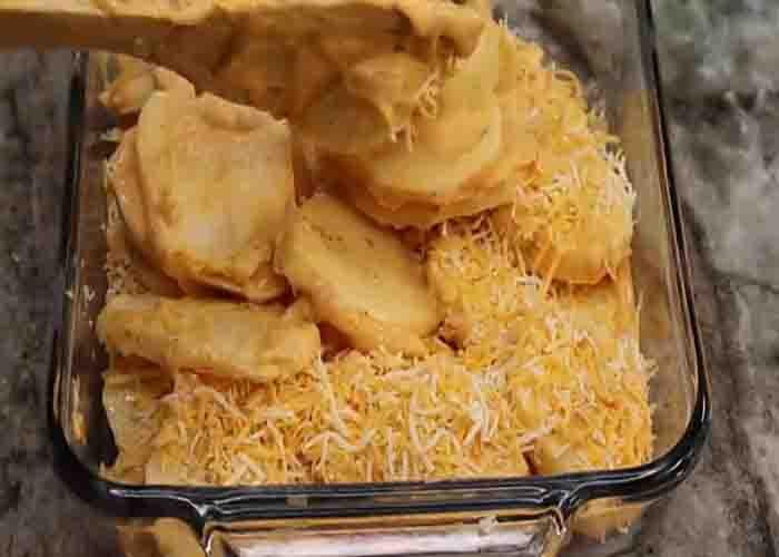 Assembling the scalloped potatoes casserole