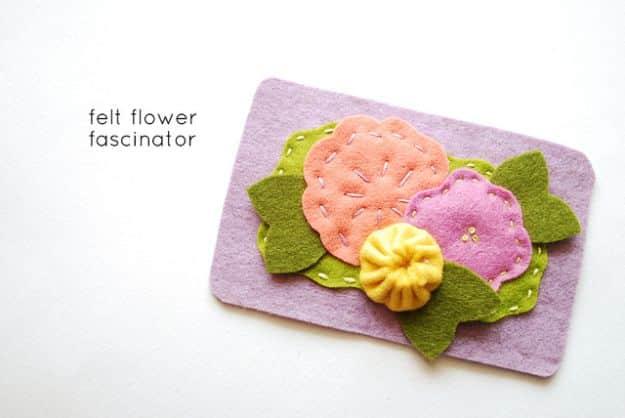 Lilac wool felt fascinator labelled felt flower fascinator, with stitched peach, pink and yellow blooms and green leaves