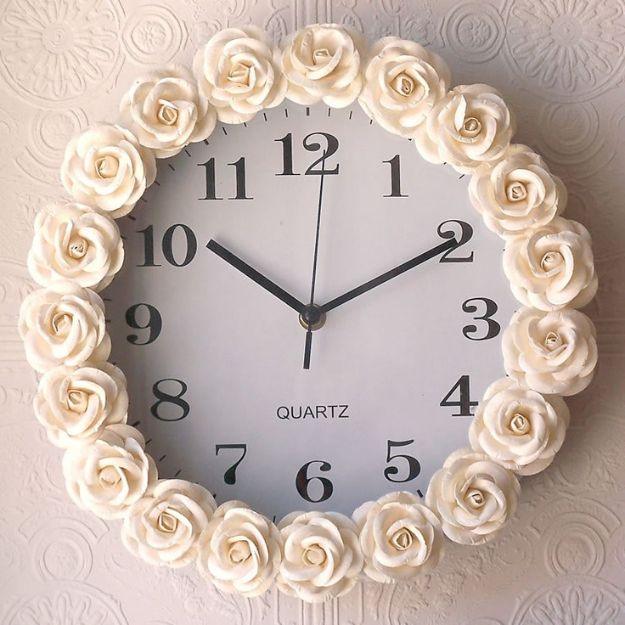 Rose inspired wall clock with a ring of cream resin roses glued around the rim on an embossed white wall