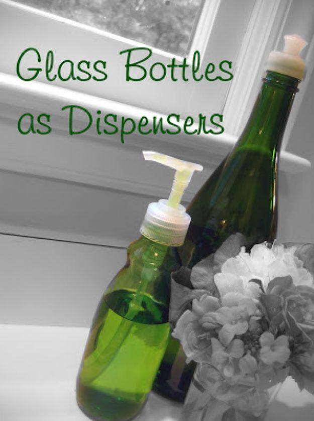 Green glass bottle fitted with a white pump beside a dark green wine bottle also used as a soap dispenser