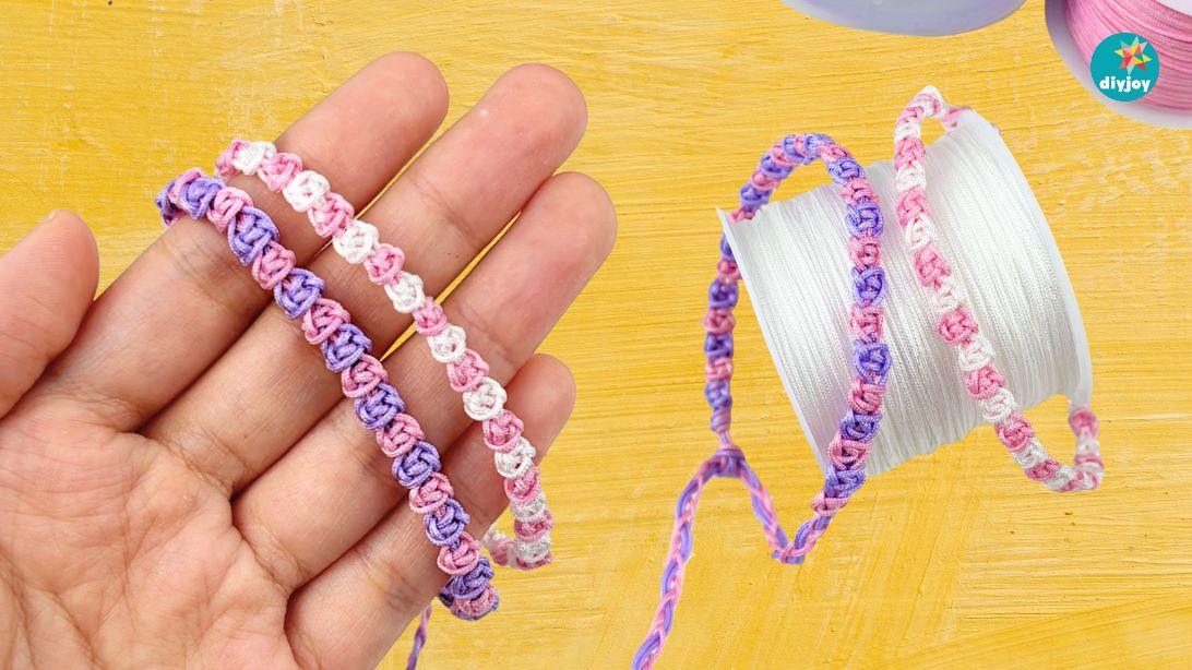 Easy macrame bracelet, pink and lilac knotted rose bracelets held across an open palm above a yellow surface