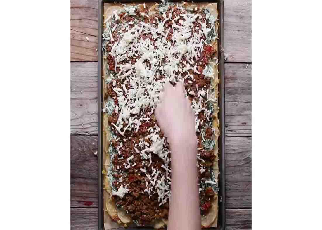 Layering the spinach and ground beef over the potatoes
