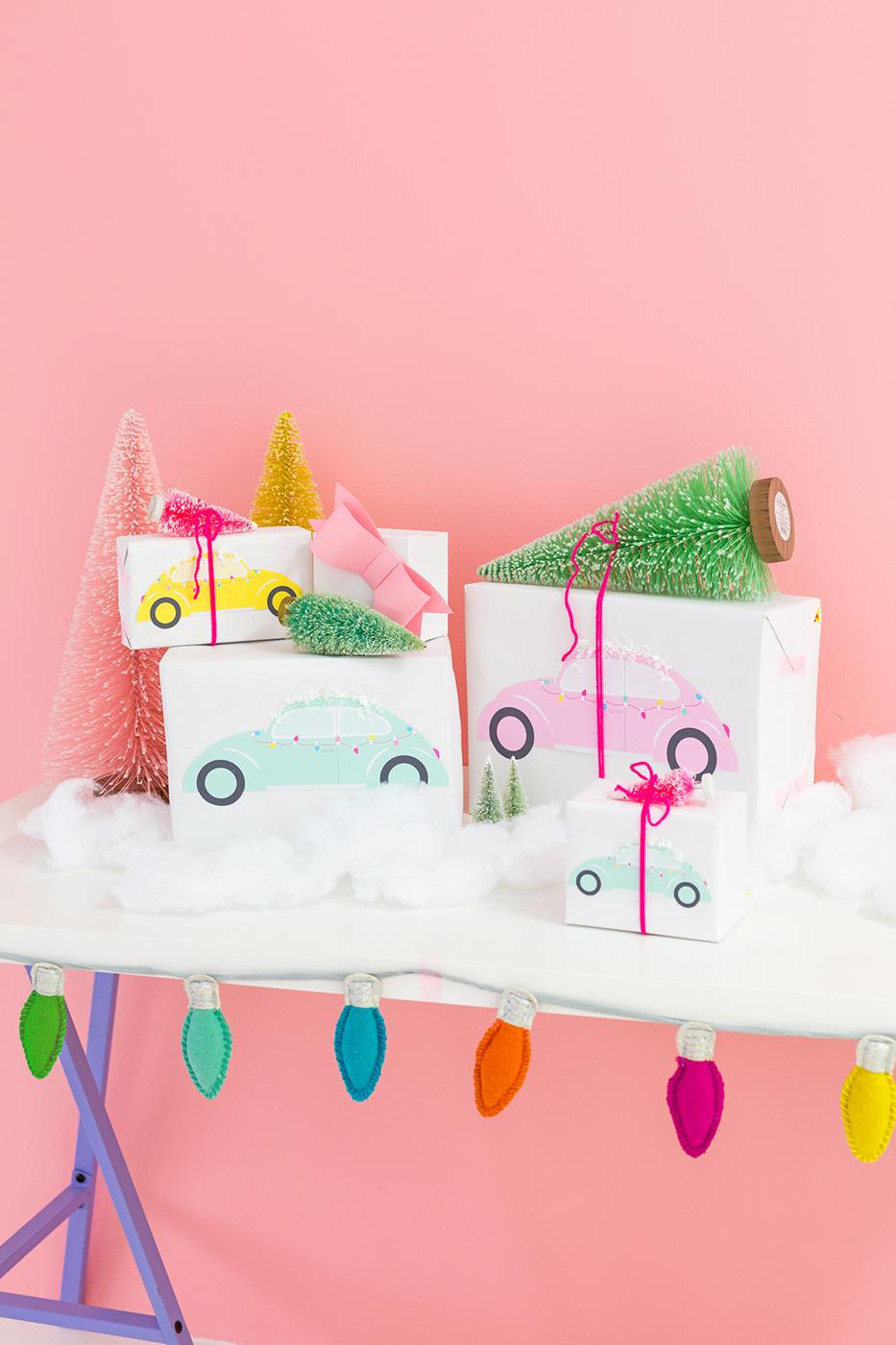 White wrapped gifts printed with pastel retro cars, each carrying a small bottle brush tree tied on with pink yarn