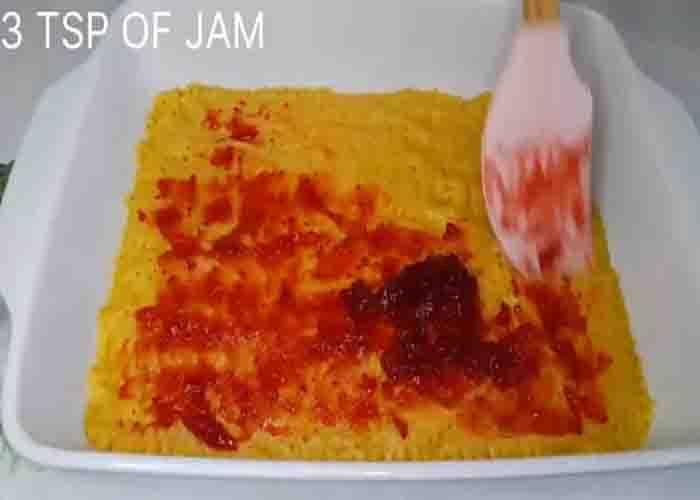 Adding the jam to the tarts