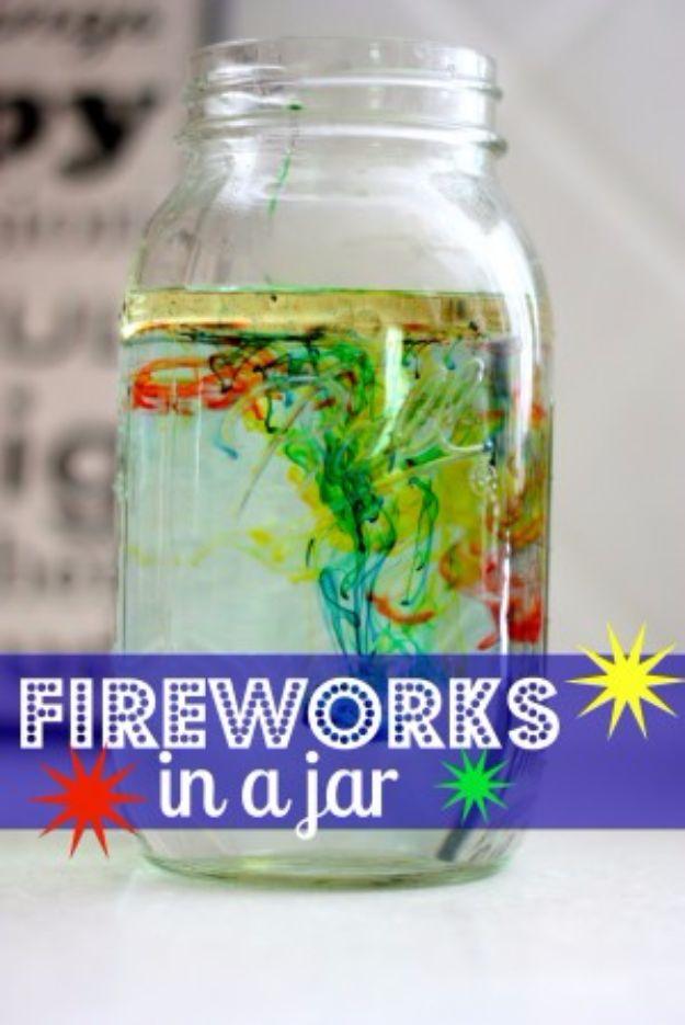 Fireworks in a jar, a mason jar of water with red green yellow and blue food coloring trailing down through a layer of oil