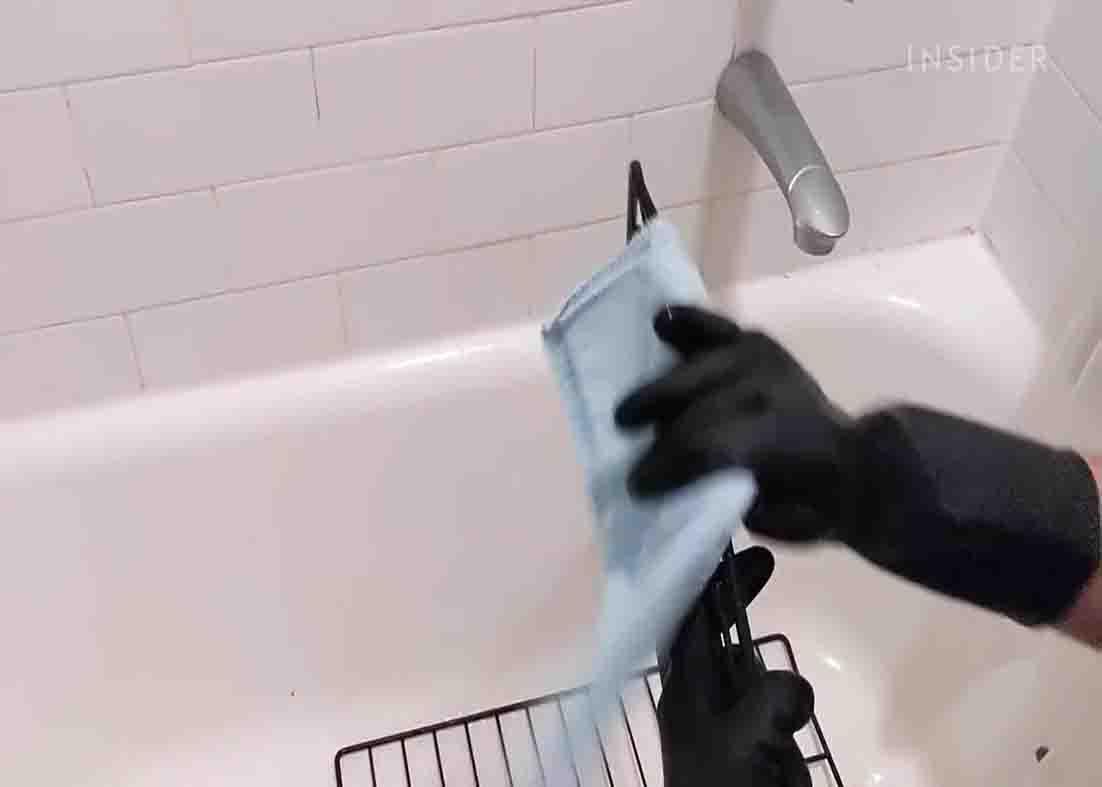 Wiping the oven racks dry after cleaning it