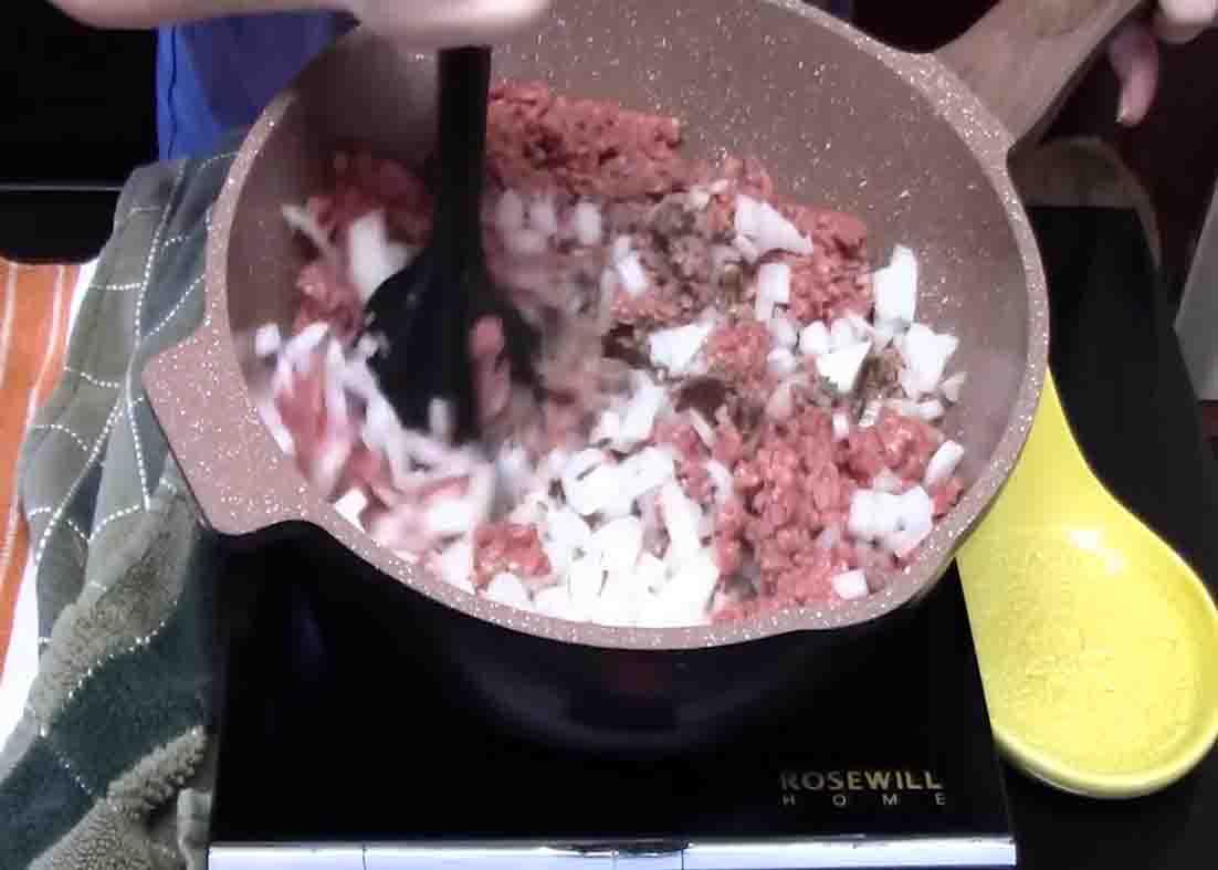 Mashing down the ground beef