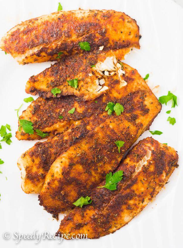 Oven baked blackened tilapia fillets coated in paprika spice rub on a sheet pan, a healthy easy fish recipe