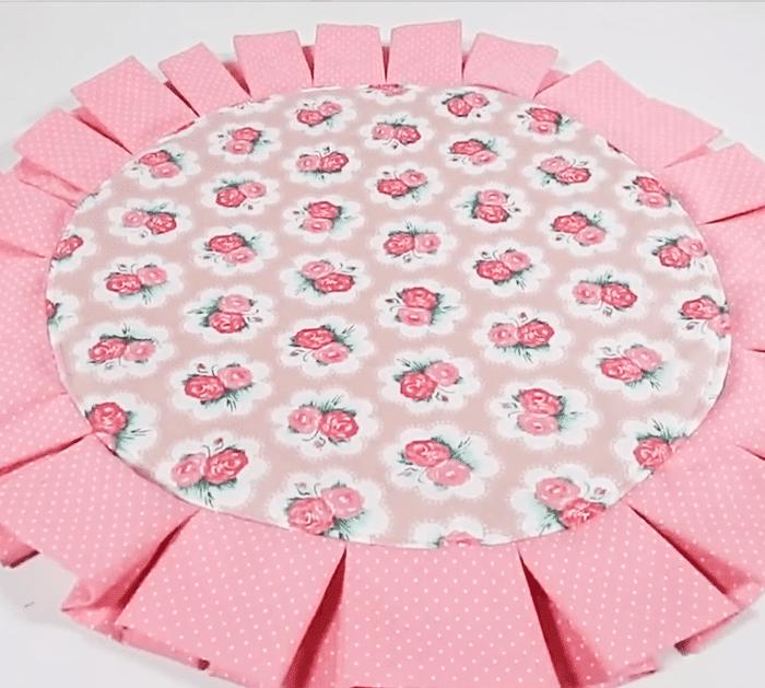 Two reversible cotton placemats on a wooden table, one floral side up and one striped, with neat topstitched edges