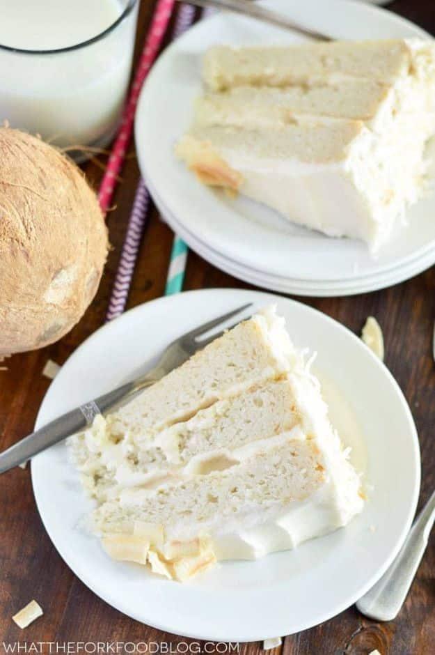 Gluten free coconut cake covered in toasted shredded coconut with a sweet coconut custard filling inside