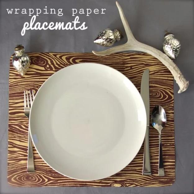 Woodgrain wrapping paper placemat graphic with a white plate, silver mercury ornaments and an antler on top