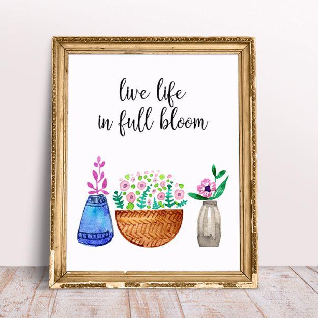 Live life in full bloom watercolor printable art in a gold frame on a white wood surface, a free printable craft