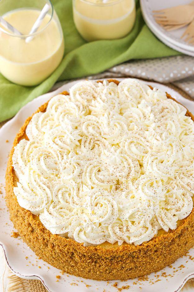 An eggnog cheesecake on a graham cracker crust, topped edge to edge with piped whipped cream rosettes