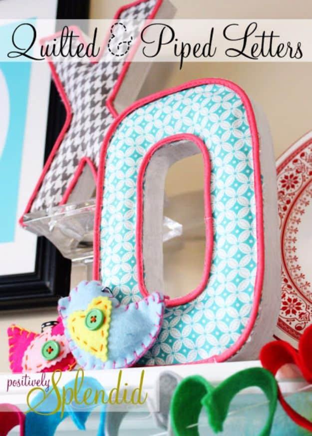 Quilting scraps project with papier mache letters covered in aqua and pink printed fabric and edged in hot pink piping