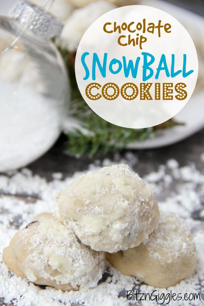 Three chocolate chip snowball cookies coated in powdered sugar piled on a snowy surface with an evergreen sprig behind