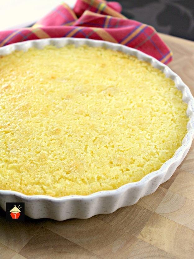 Lemon impossible pie with a self forming crust and a soft lemon coconut custard set in a round pie plate