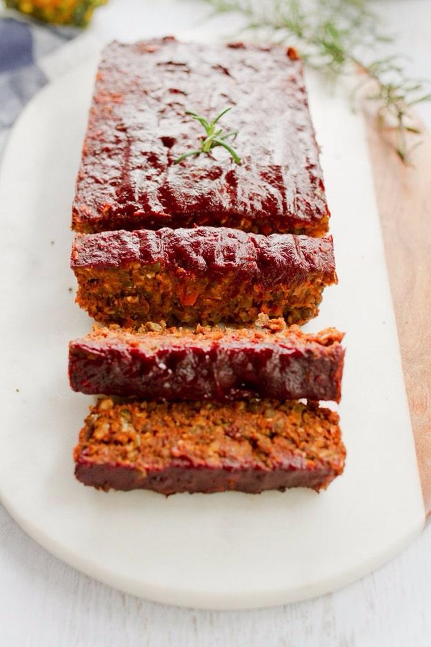 Sliced vegan lentil loaf with a dark maple balsamic tomato glaze, made with lentils, walnuts and oats