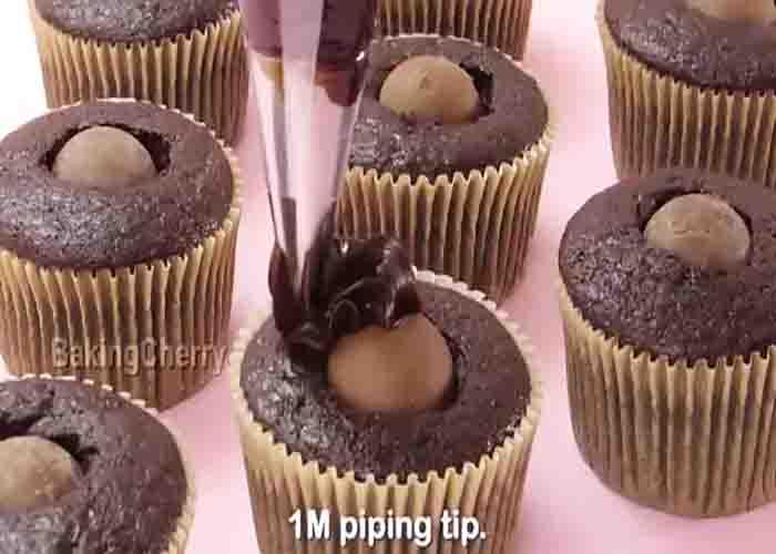 Adding the ganache over the chocolate truffle cupcakes