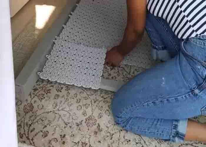 Adding the IKEA floor tiles to the wooden frame to make the privacy wall