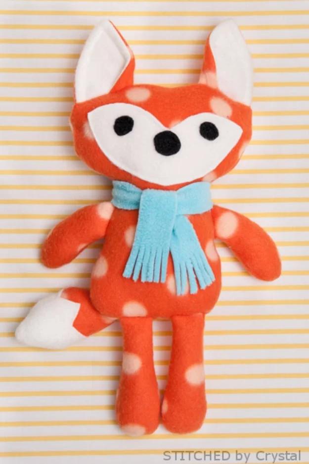 Sewing projects for boys stuffed fox toy in orange polka dot fleece with a white face and a pale blue fringed scarf